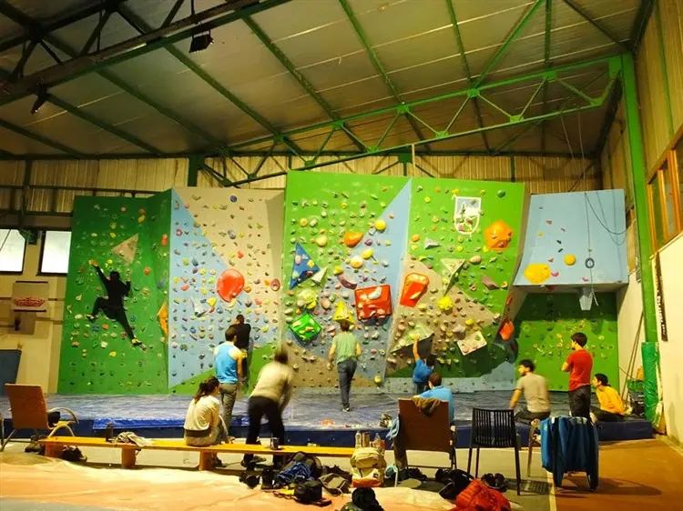 Climbers bouldering and resting in the indoor climbing room