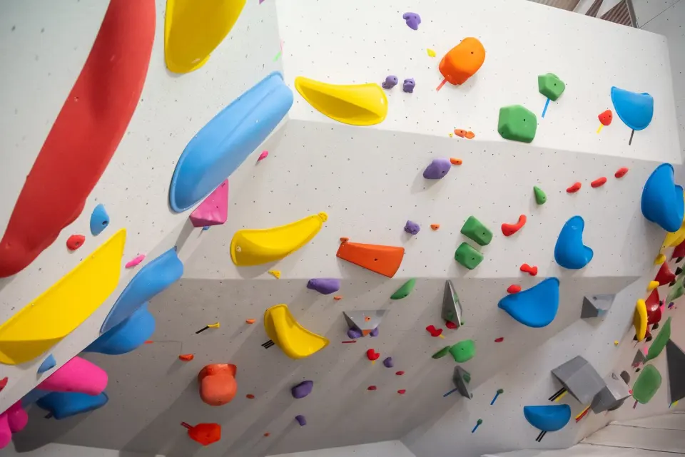 Freshly set holds on an angled bouldering wall