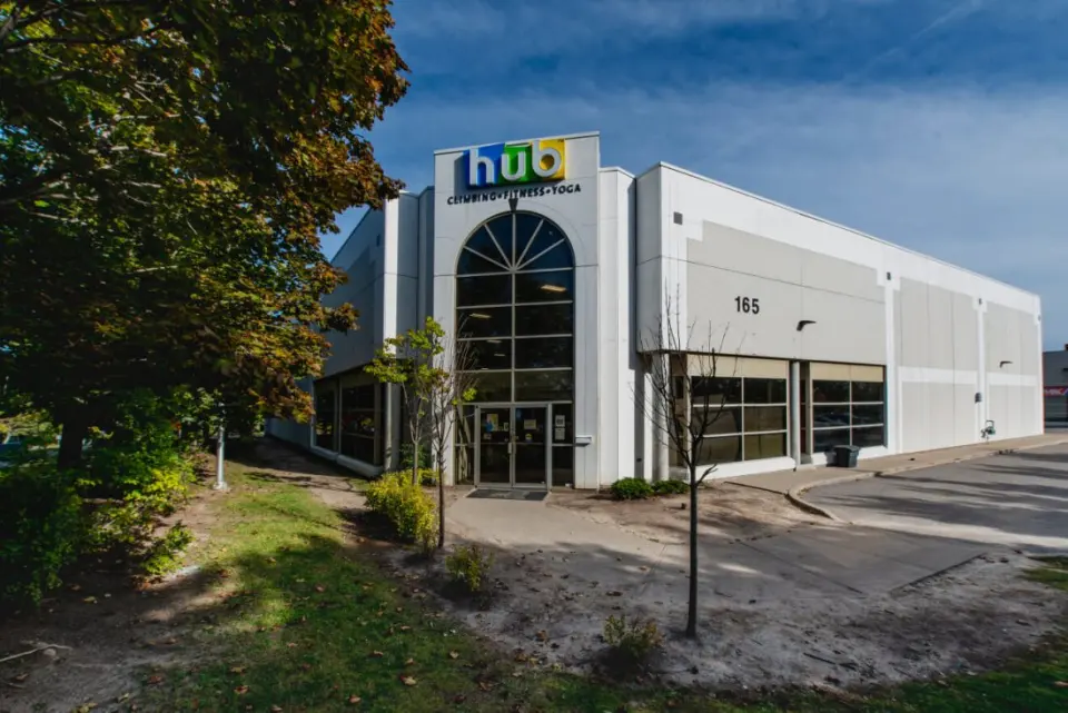 Front of the gym building with its arched glass entrance and Hub sign