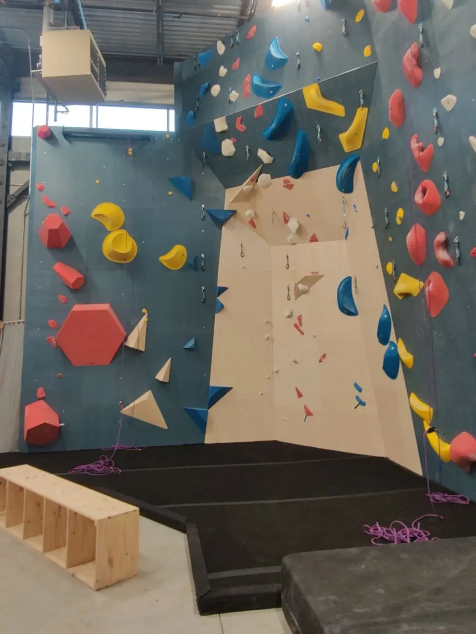 Lead wall with quickdraws and a recessed corner above padded flooring