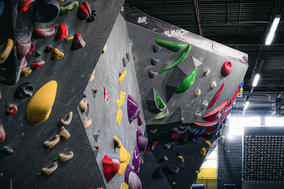 Angled bouldering walls with large volumes and bright holds
