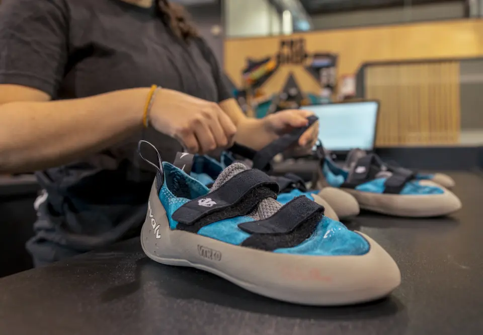 Rental climbing shoes lined up on the front desk