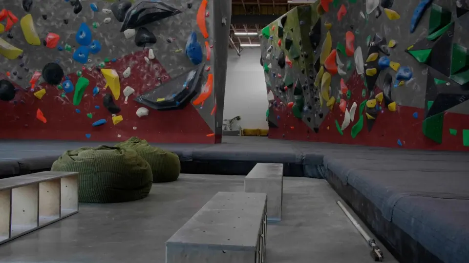 Bouldering walls with deep matting and bean bags in the lounge area