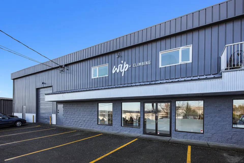 The gym's grey building with the WIP Climbing sign above the entrance