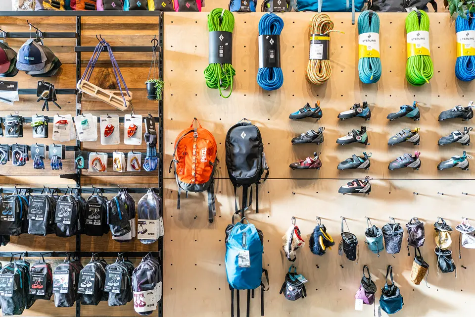 Shop wall with ropes, climbing shoes, chalk bags and backpacks on display