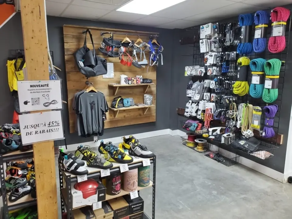 Climbing shop corner with ropes, quickdraws, harnesses and climbing shoes on display