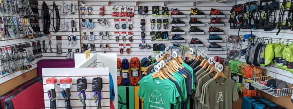 Gear shop stocked with climbing shoes, harnesses, quickdraws, ropes and T-shirts