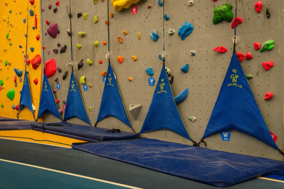 Row of auto-belays at the foot of the climbing wall