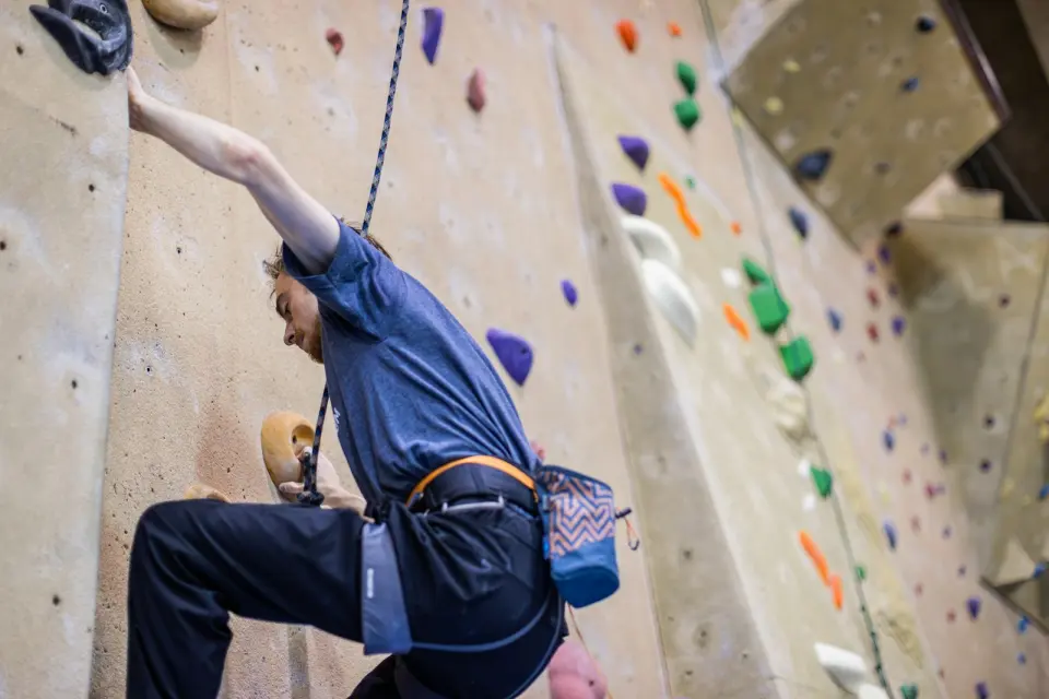 Climber on a top rope on the roped wall