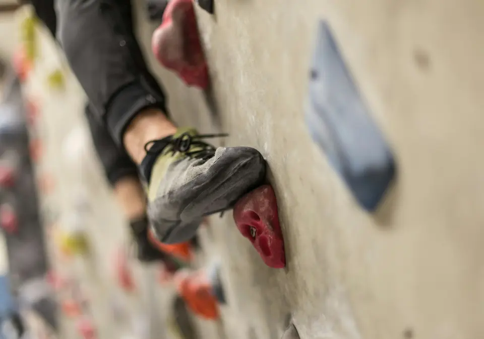Climbing shoe on a red foothold