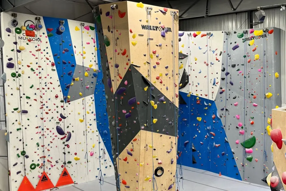 Roped climbing walls and a freestanding tower with top-rope lines and auto-belays