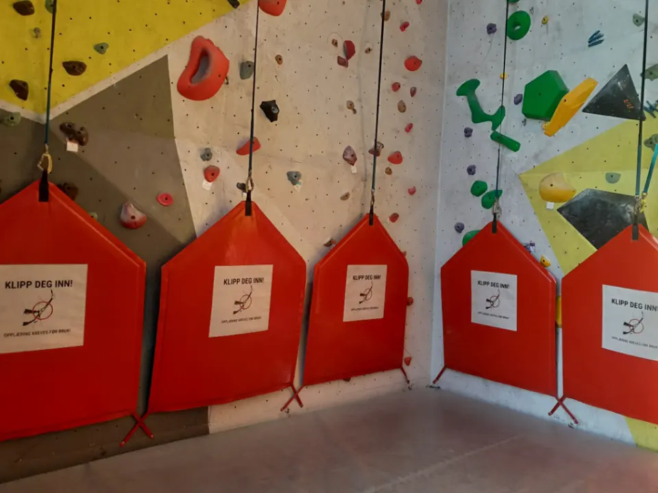 Auto-belay lines with red gate pads in the auto-belay room
