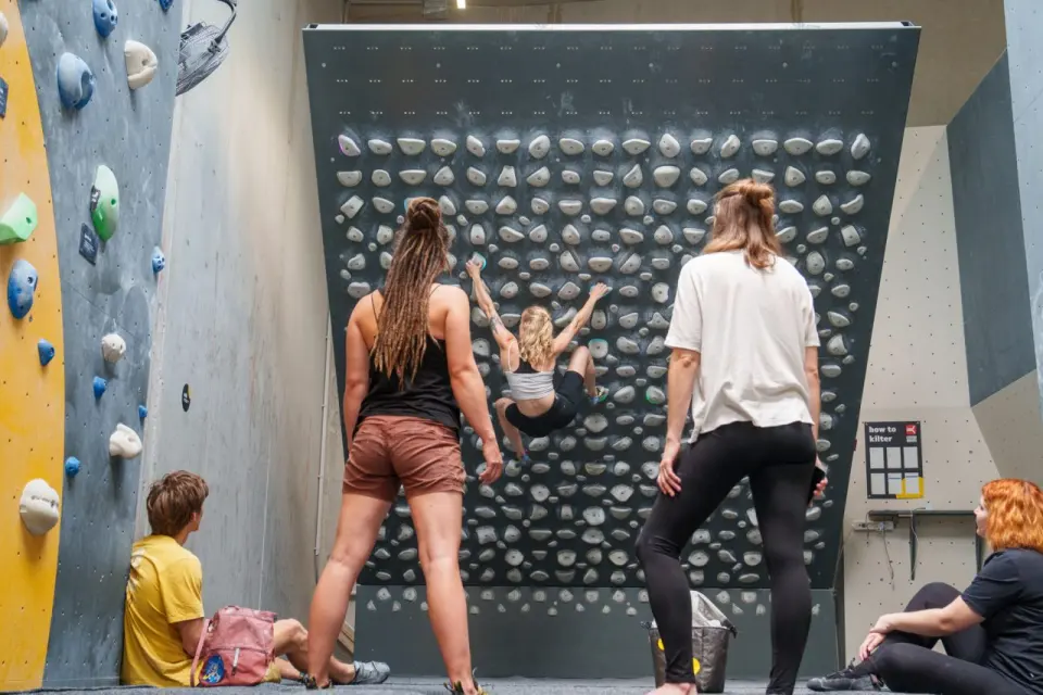 Climbers watching someone on the Kilter Board