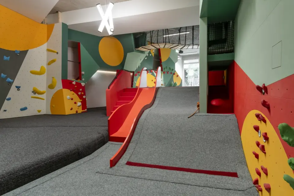 Children's area with a slide and climbing walls