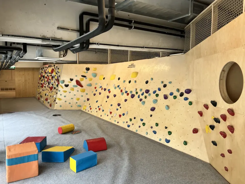 Low wall with colourful holds and soft play blocks in the children's area