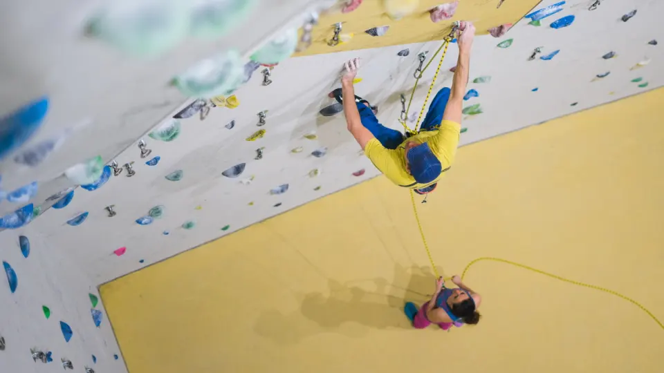 Lead climber on an overhanging wall above a belayer