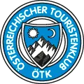 Round blue Österreichischer Touristenklub emblem with mountains