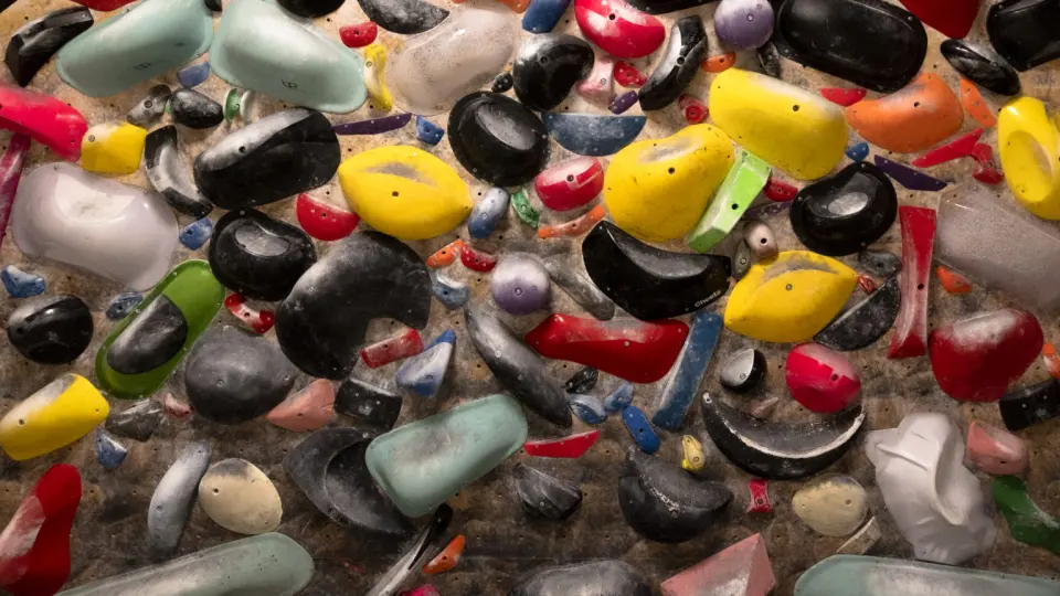 Wall packed with holds of many colours and shapes