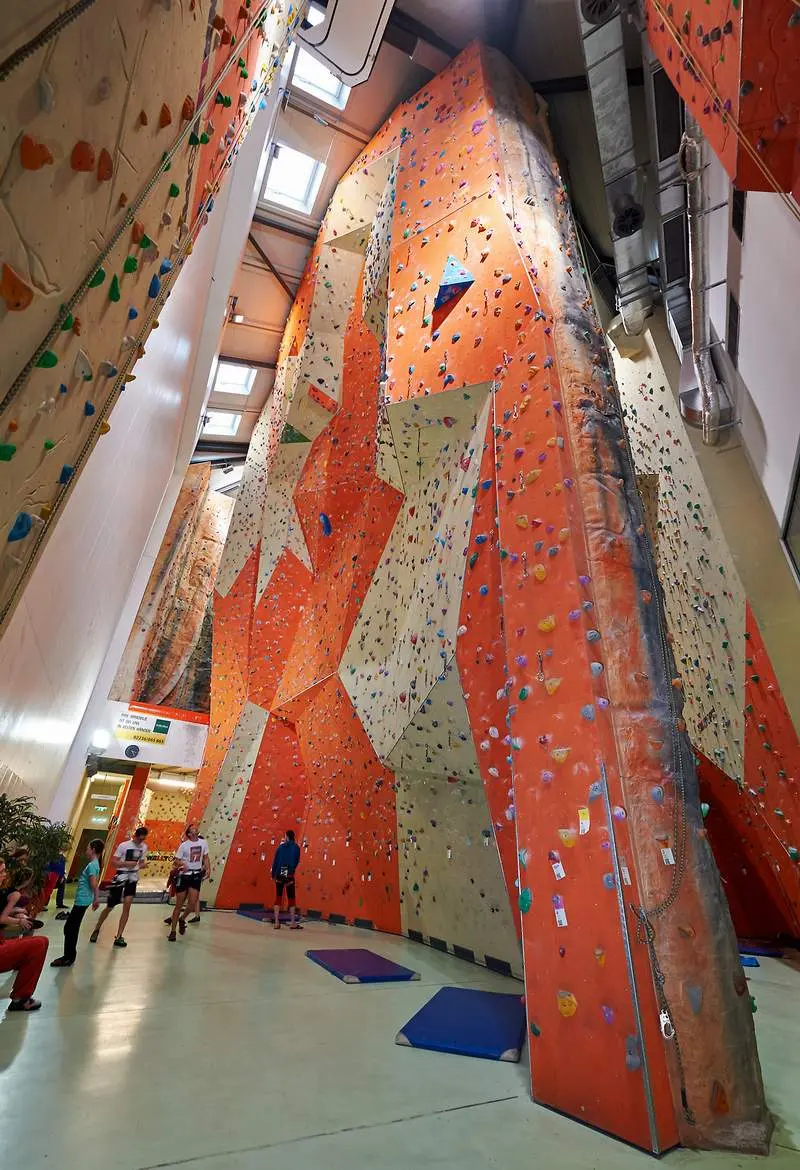 Towering orange and cream lead walls under skylights