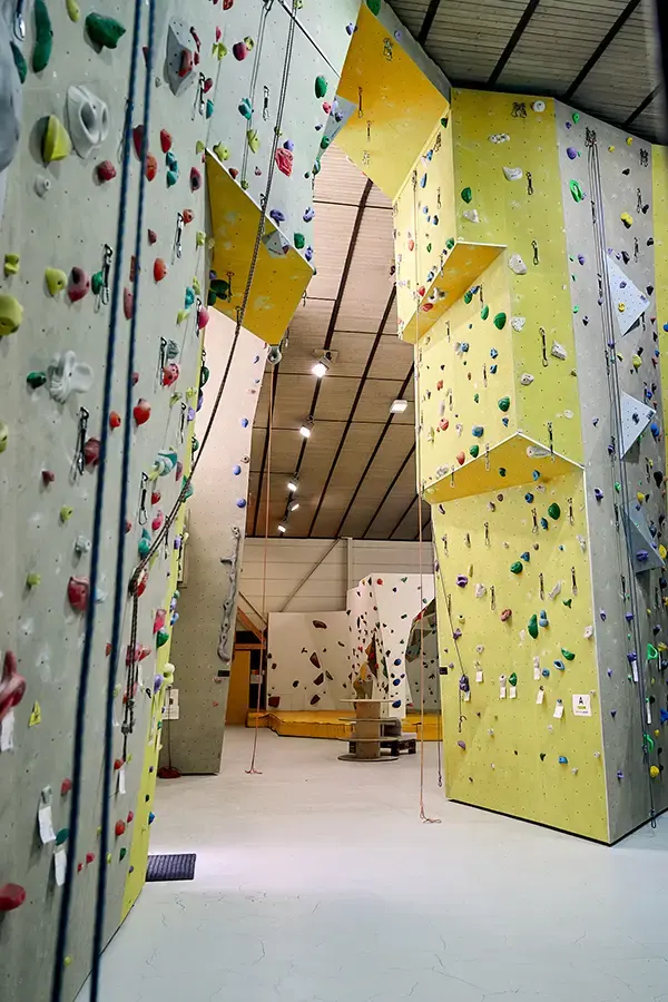 Tall yellow and grey rope walls with top ropes hanging down