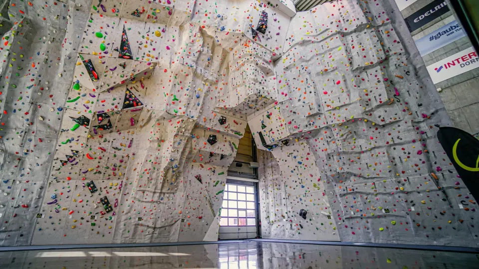 The 17-metre overhanging competition wall at K1 Kletterhalle Dornbirn, covered in colourful holds