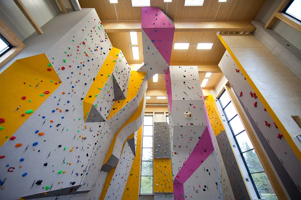 Grey, yellow and pink lead walls and a tall tower under a timber roof
