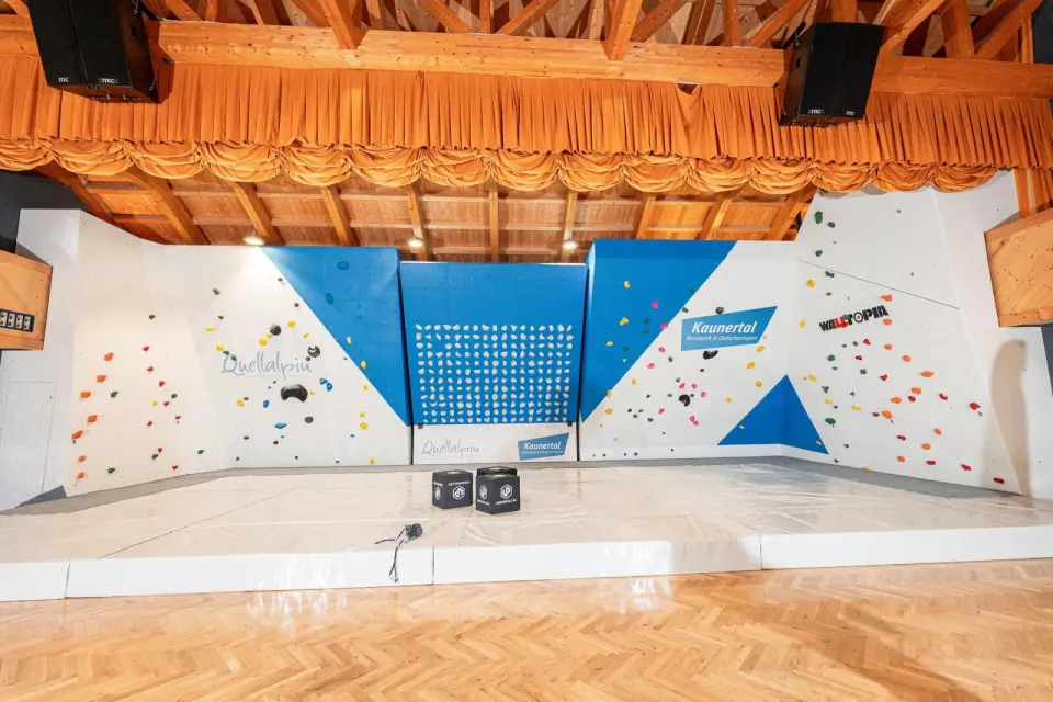 Front view of the bouldering wall with the Kilterboard in the middle and white mats