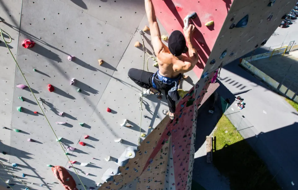 View from above of a climber on a steep section of the outdoor wall