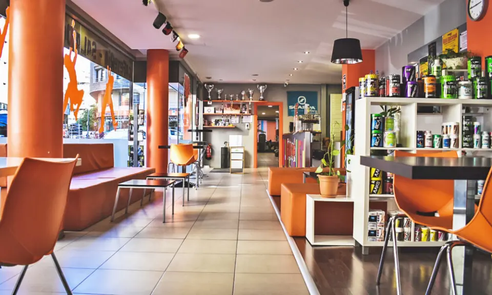 Café with orange seating and shelves of sports nutrition products