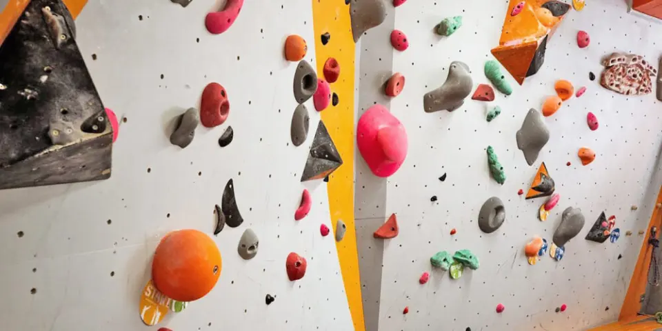Bouldering walls set with coloured holds and volumes