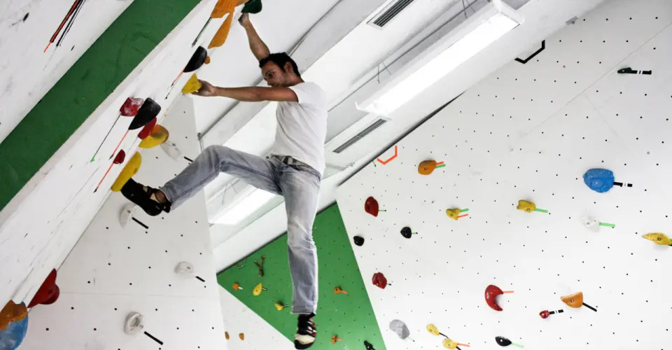 Climber moving out on the overhanging bouldering wall