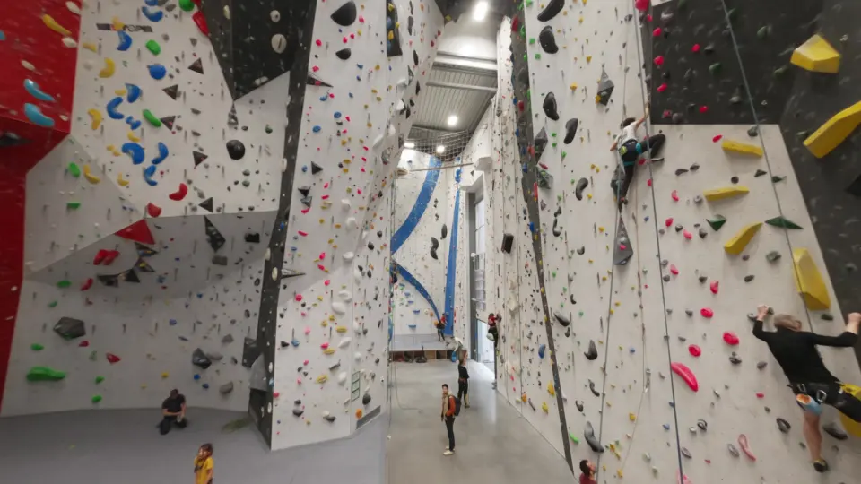 Climbers on the tall rope walls of the lead hall