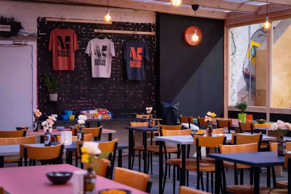 The bar's seating area, with Arsenaal T-shirts and board games along the back wall
