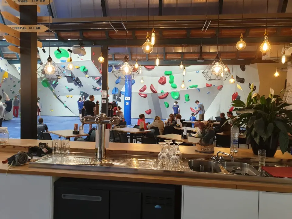 View from behind the bar over the seating area to the bouldering walls