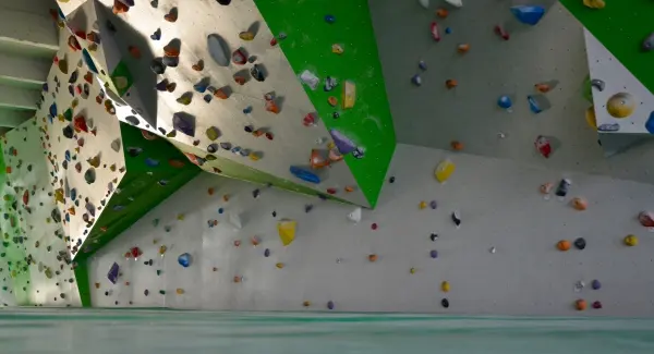 Angled white and green panels dotted with coloured holds