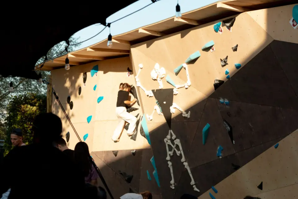 The roofed outdoor boulder in evening sun, with skeleton-shaped holds