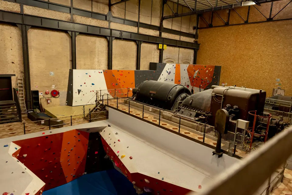 Bouldering walls beside the old turbines in Alpamayo's power-station hall in Beringen