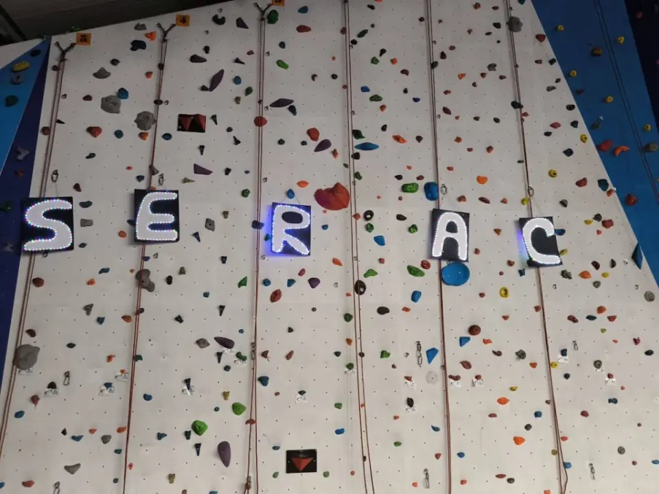 Lit SERAC letters hung across the roped wall