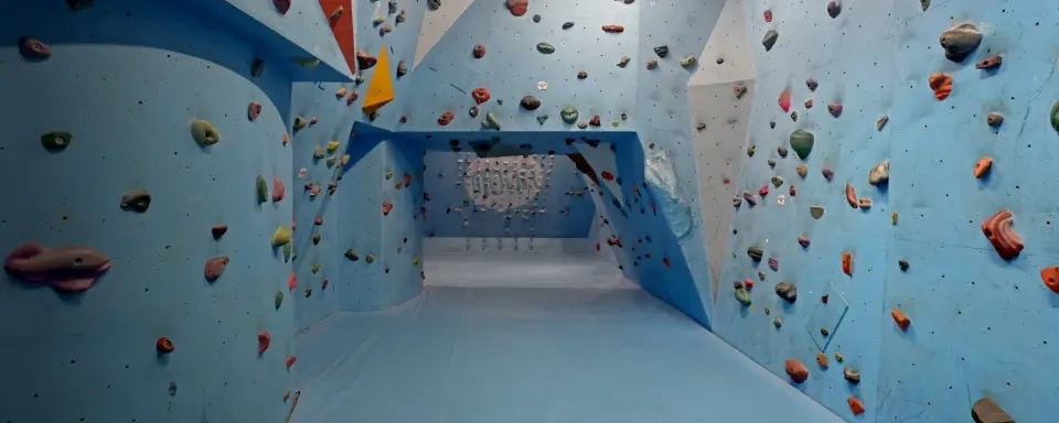 Blue bouldering walls and matted corridor at Willowburn
