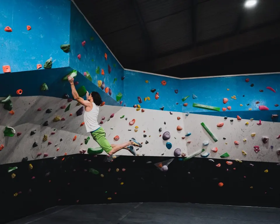 Climber moving across the long bouldering wall