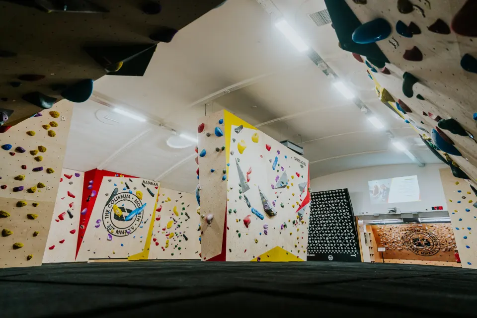 Main bouldering hall with freestanding boulders and black matting