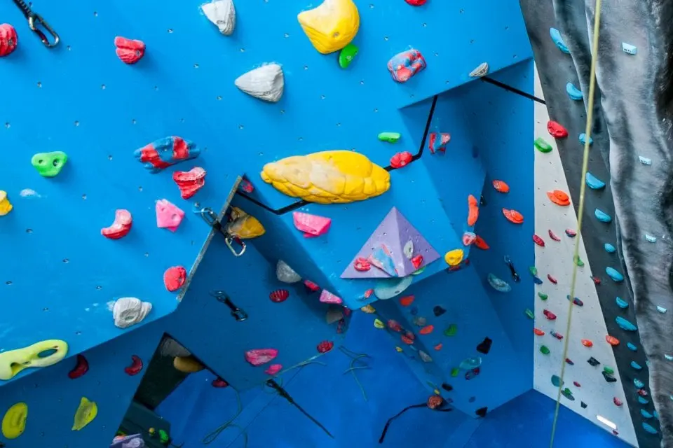 Blue overhanging walls and a roped grey slab