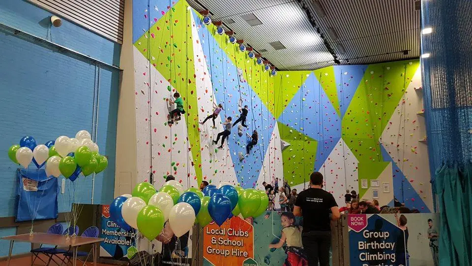 The full climbing wall with climbers on several lines