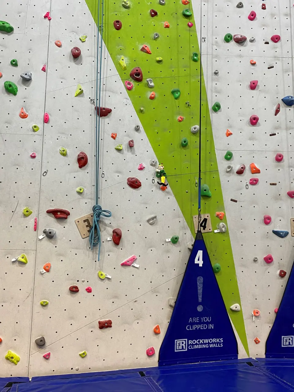 Holds and a numbered rope line on the wall