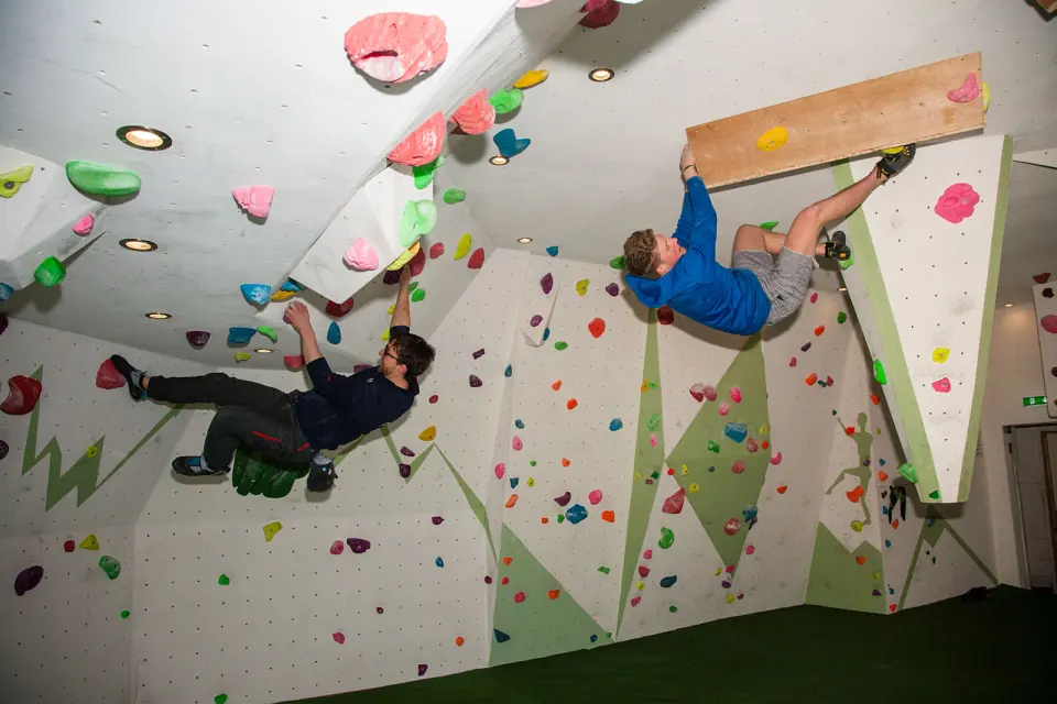 Climbers on the overhangs in a bouldering room