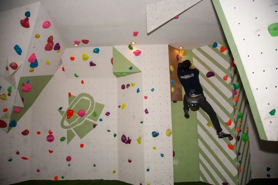 Climber on a steep bouldering arete