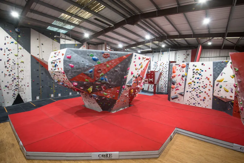 Freestanding boulder on red matting in the main hall