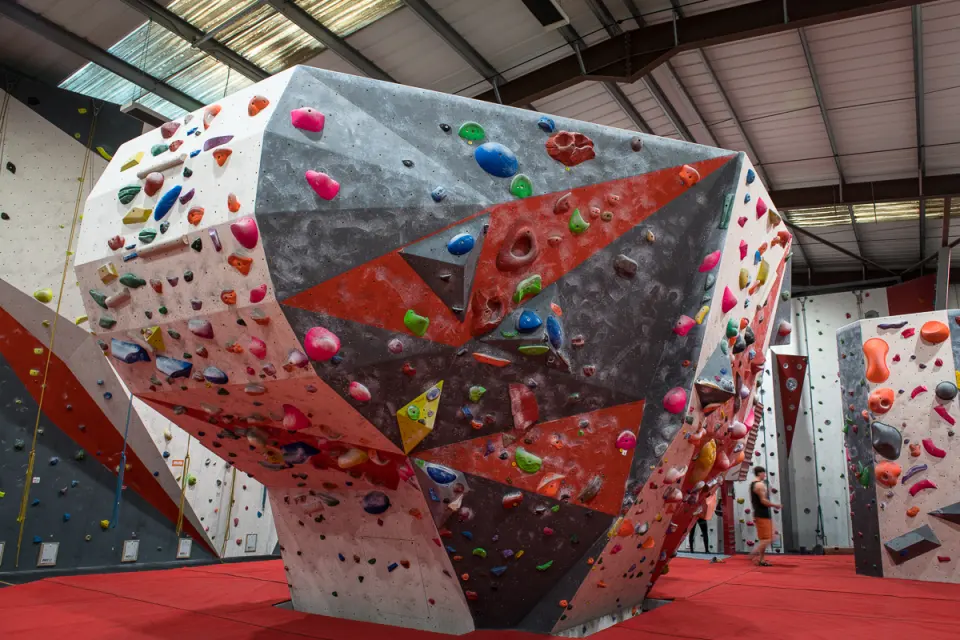 Angular freestanding boulder covered in holds