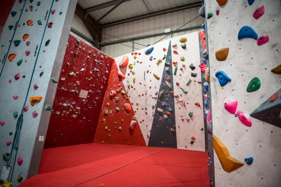 Red and grey bouldering corner above the matting