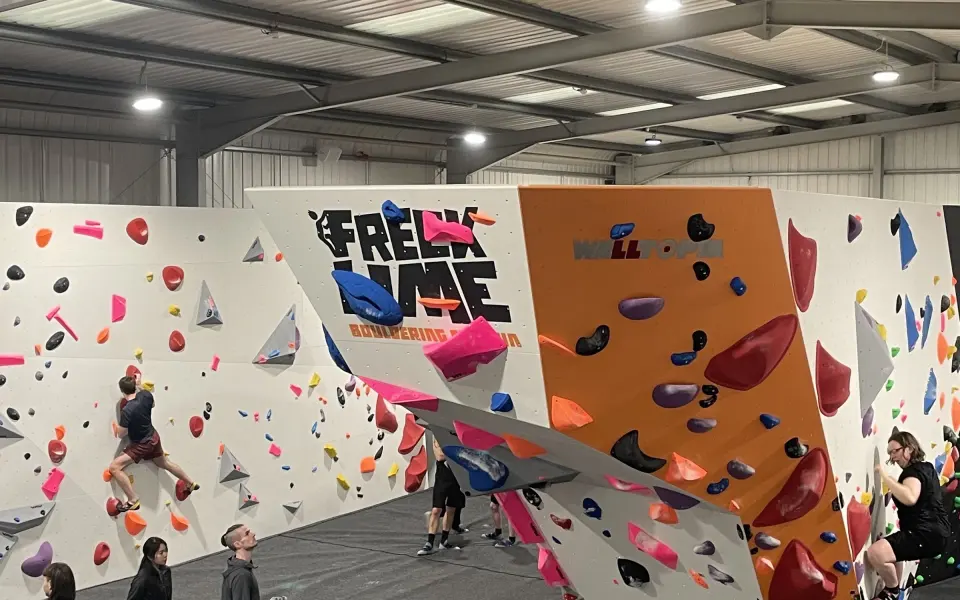 Freeklime-branded overhanging boulder in the middle of the Lincoln bouldering hall
